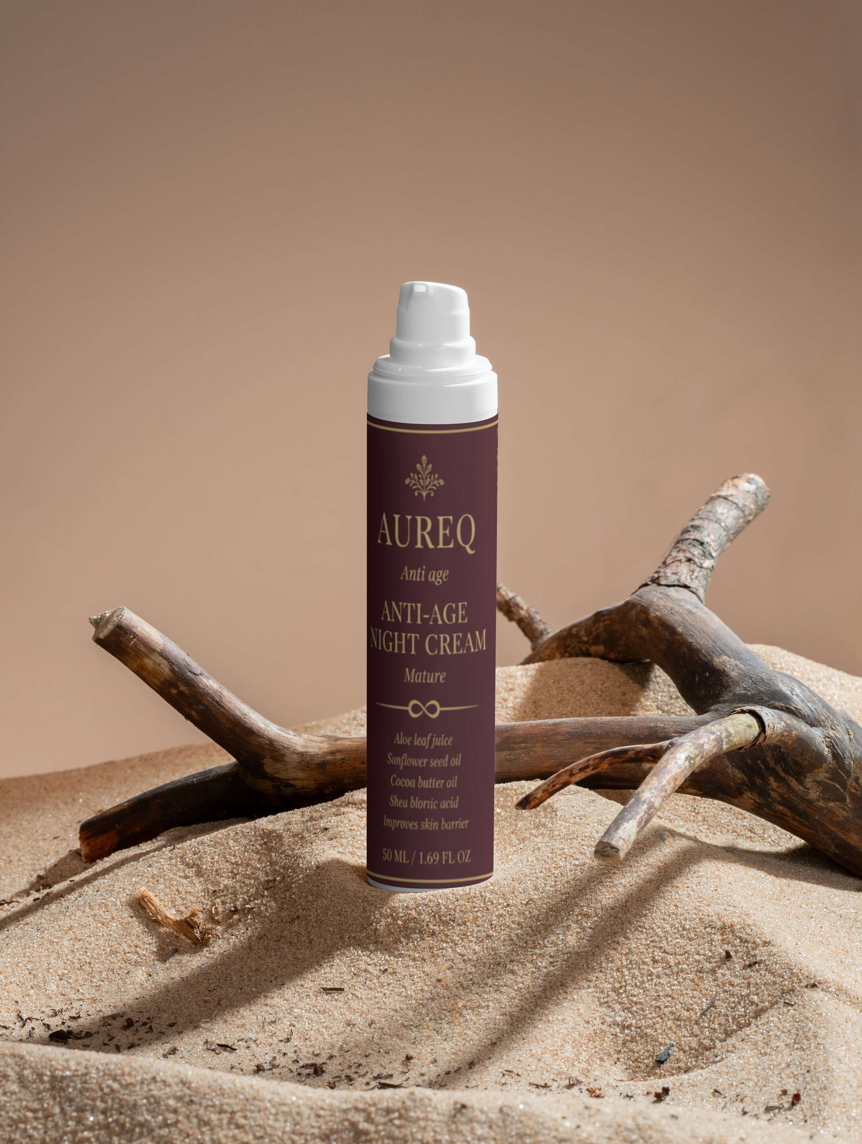 Collagen Anti-Age Night Cream bottle displayed on sand with natural elements, highlighting its hydrating properties.