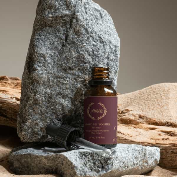 Antioxidant Ginkgo Gel Booster in a stylish dark bottle, placed on a textured stone background.
