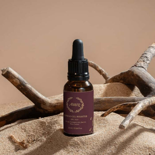 Antioxidant Ginkgo Gel Booster in a dropper bottle on sandy surface with natural elements.