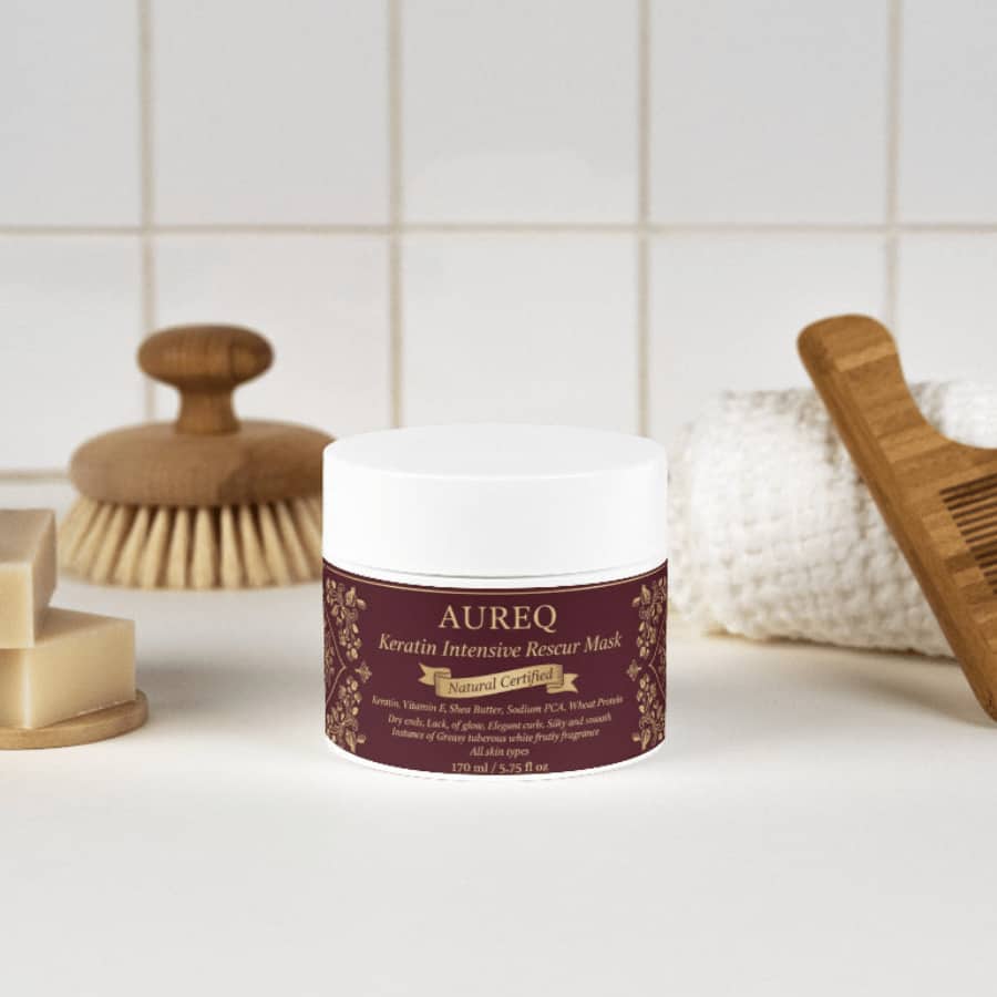 AUREQ Keratin Intensive Rescue Hair Mask in a stylish jar, surrounded by beauty products for hair care.