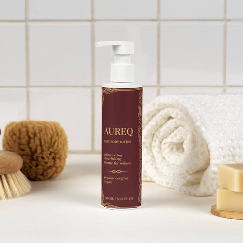 AUREQ Baby Body Lotion - Organic Hydration for Delicate Skin on a bathroom countertop with towels.