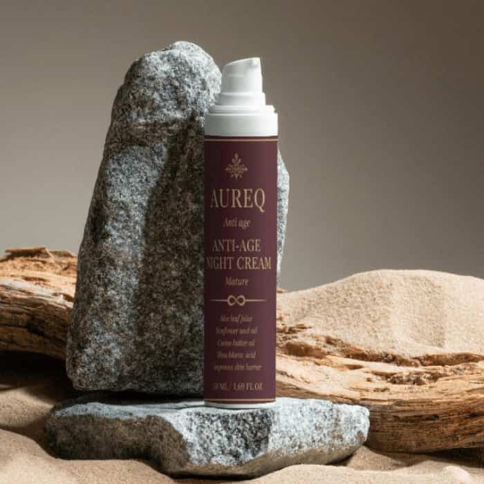 Collagen Anti-Age Night Cream bottle on stone background, promoting hydration and skin firmness overnight.